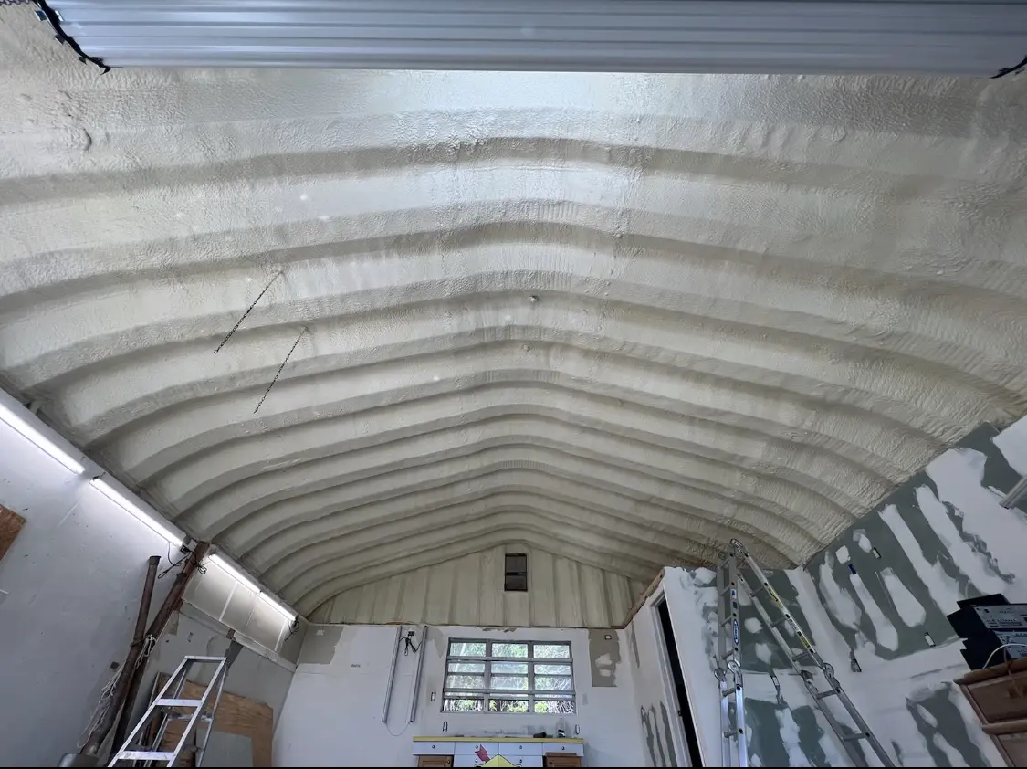 Spray polyurethane foam applied to the underside of a metal roof deck in Somerset